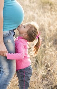 a pregnant mothe with daughter 